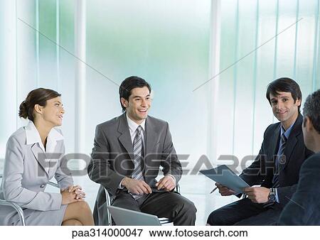 Business colleagues having meeting, smiling View Large Photo Image Stock Photo - Business colleagues having meeting, smiling. Fotosearch