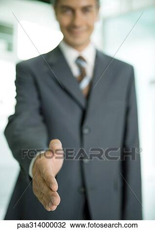 Businessman holding out hand for handshake View Large Photo Image Stock Image - Businessman holding out hand for handshake. Fotosearch