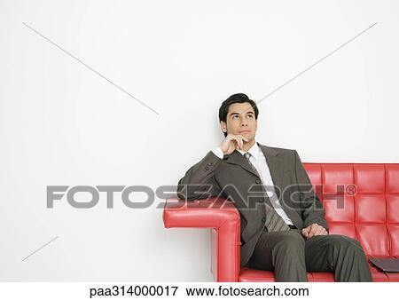 Businessman sitting on couch View Large Photo Image Stock Photo - Businessman sitting on couch. Fotosearch