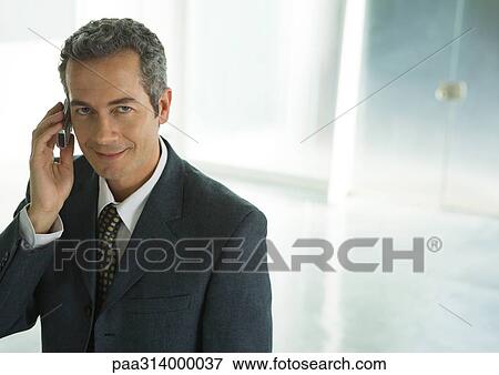 Stock Photo - Businessman using cell phone. Fotosearch