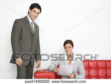 Businesswoman and businessman in office lobby View Large Photo Image Stock Image - Businesswoman and businessman in office lobby. Fotosearch