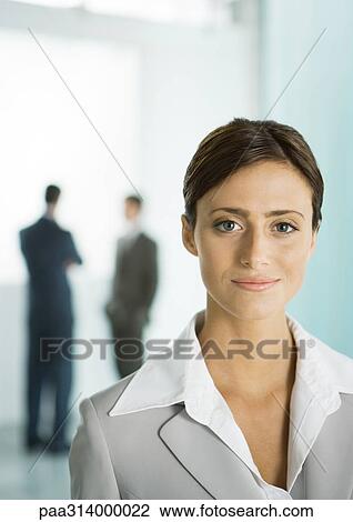 Stock Image - Businesswoman in office lobby, portrait. Fotosearch