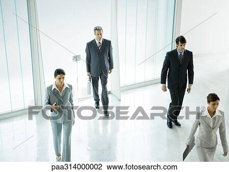 Four executives entering office building lobby View Large Photo Image Stock Image - Four executives entering office building lobby. Fotosearch