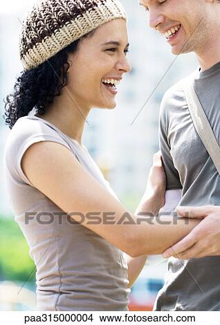 Young couple laughing View Large Photo Image Picture - Young couple laughing. Fotosearch