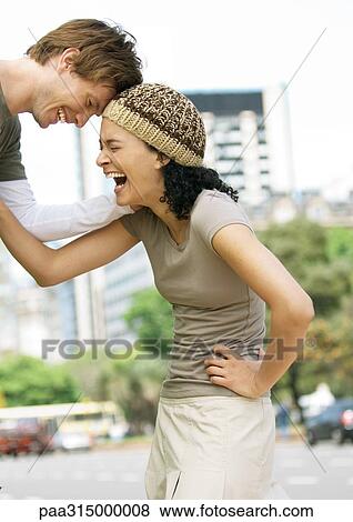 Young couple laughing View Large Photo Image Stock Photo - Young couple laughing. Fotosearch
