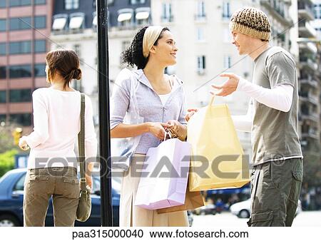 Young couple with shopping bags View Large Photo Image Stock Image - Young couple with shopping bags. Fotosearch