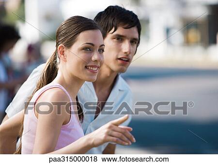 Young couple, woman pointing View Large Photo Image Stock Photo - Young couple, woman pointing. Fotosearch