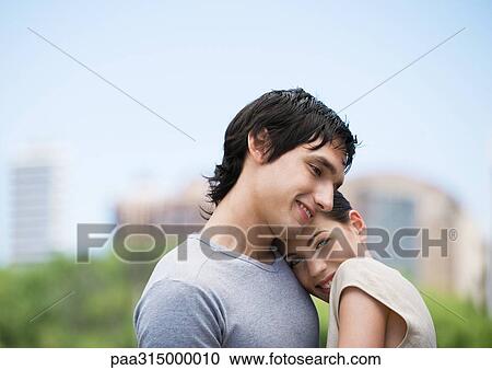 Young woman resting head on boyfriend's shoulder View Large Photo Image Stock Image - Young woman resting head on boyfriend's shoulder. Fotosearch