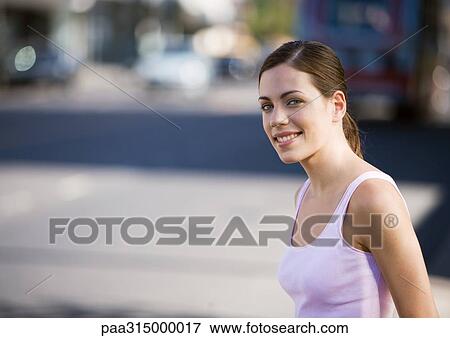 Young woman wearing tank top View Large Photo Image Stock Photo - Young woman wearing tank top. Fotosearch