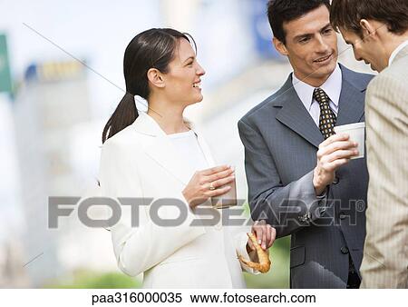Business colleagues having coffee outdoors View Large Photo Image Stock Photography - Business colleagues having coffee outdoors. Fotosearch