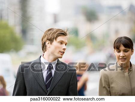 Businessman and woman chatting together View Large Photo Image Stock Image - Businessman and woman chatting together. Fotosearch