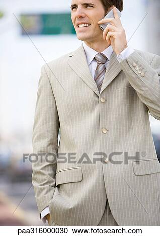 Businessman using cell phone View Large Photo Image Stock Image - Businessman using cell phone. Fotosearch