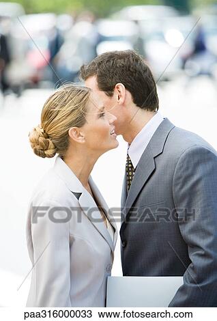 Businessman whispering to businesswoman View Large Photo Image Stock Image - Businessman whispering to businesswoman. Fotosearch