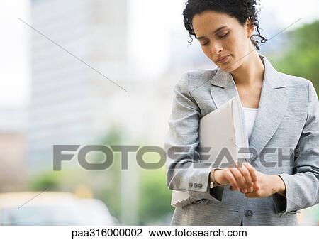 Businesswoman checking watch View Large Photo Image Stock Image - Businesswoman checking watch. Fotosearch