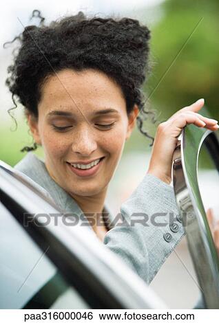Businesswoman getting into car View Large Photo Image Stock Photograph - Businesswoman getting into car. Fotosearch