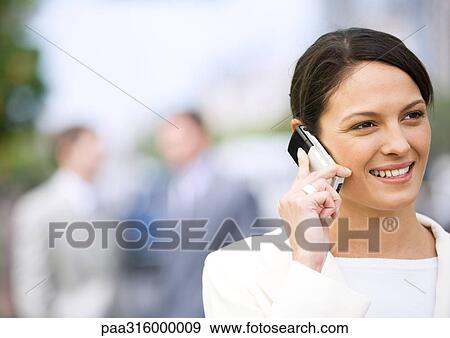 Stock Photo - Businesswoman using cell phone. Fotosearch