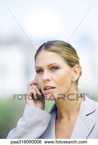 Businesswoman using cell phone View Large Photo Image Stock Photograph - Businesswoman using cell phone. Fotosearch