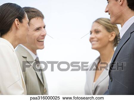 Four business associates laughing together View Large Photo Image Stock Photography - Four business associates laughing together. Fotosearch