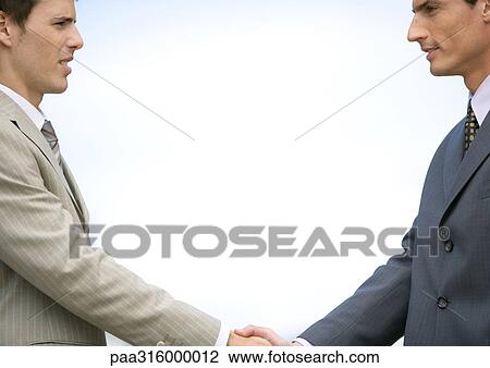 Two young businessmen shaking hands View Large Photo Image Stock Image - Two young businessmen shaking hands. Fotosearch