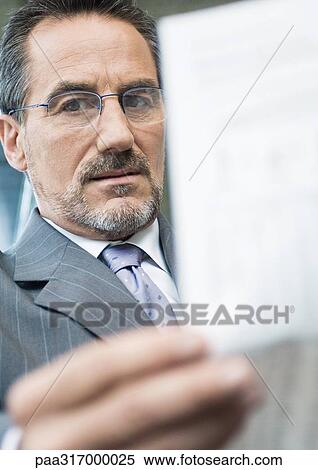Businessman holding up bill View Large Photo Image Stock Photography - Businessman holding up bill. Fotosearch