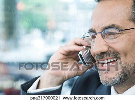 Businessman talking on cell phone View Large Photo Image Stock Image - Businessman talking on cell phone. Fotosearch
