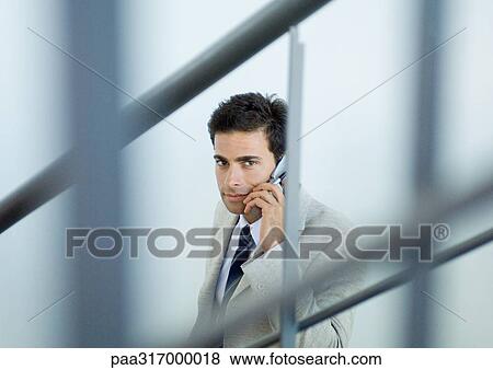 Stock Photo - Businessman using cell phone. Fotosearch