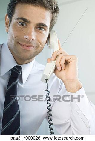 Businessman using landline phone View Large Photo Image Stock Photograph - Businessman using landline phone. Fotosearch