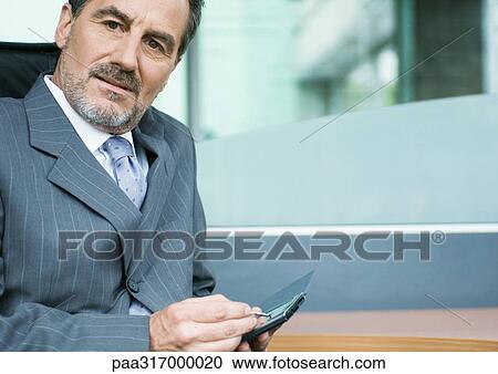Businessman using PDA View Large Photo Image Stock Image - Businessman using PDA. Fotosearch
