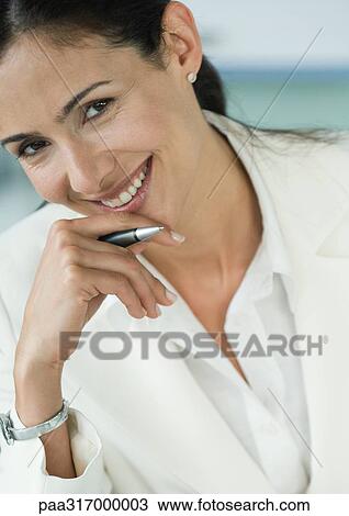 Businesswoman holding pen and smiling View Large Photo Image Stock Image - Businesswoman holding pen and smiling. Fotosearch