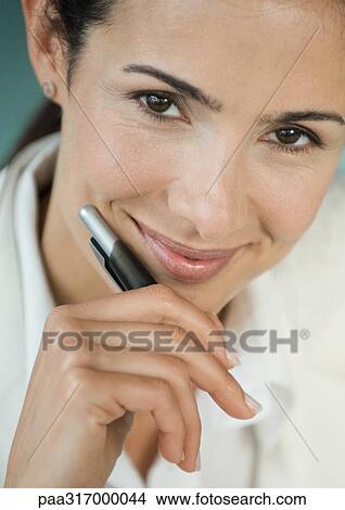 Businesswoman holding pen, smiling, portrait View Large Photo Image Picture - Businesswoman holding pen, smiling, portrait. Fotosearch