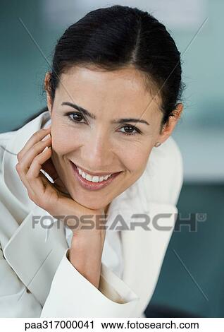 Stock Image - Businesswoman smiling, portrait. Fotosearch