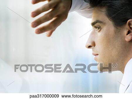 Man looking through window View Large Photo Image Stock Photo - Man looking through window. Fotosearch