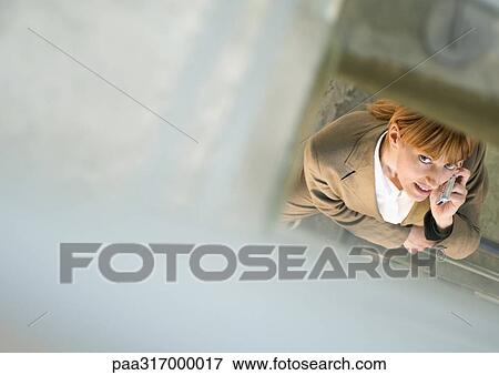 Woman using cell phone, high angle view View Large Photo Image Stock Photo - Woman using cell phone, high angle view. Fotosearch