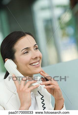 Woman using landline phone View Large Photo Image Stock Image - Woman using landline phone. Fotosearch