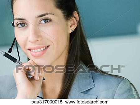 Stock Photography - Woman wearing headset. Fotosearch