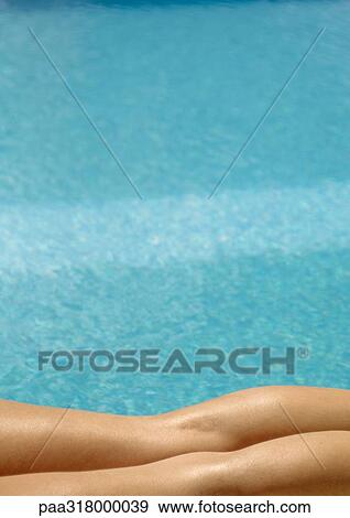 Woman lying by pool, partial view of legs View Large Photo Image Stock Photo - Woman lying by pool, partial view of legs. Fotosearch