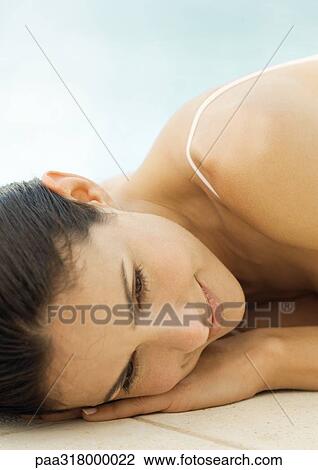 Woman lying on floor, close-up of face View Large Photo Image Stock Image - Woman lying on floor, close-up of face. Fotosearch