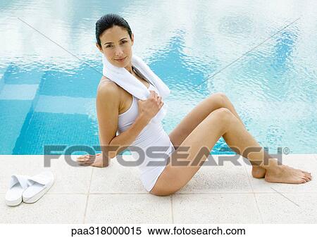 Woman sitting by edge of pool View Large Photo Image Stock Photography - Woman sitting by edge of pool. Fotosearch