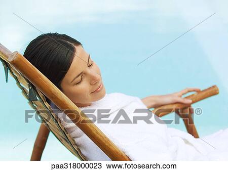 Woman sitting in deckchair, wearing bathrobe View Large Photo Image Stock Image - Woman sitting in deckchair, wearing bathrobe. Fotosearch