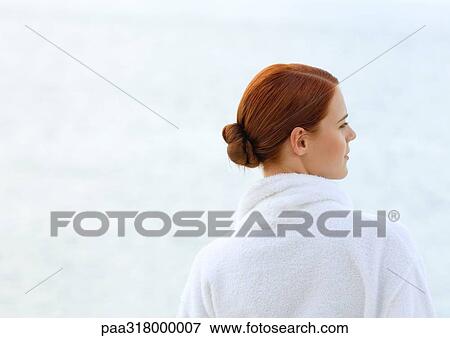 Woman wearing bathrobe, overlooking sea, rear view View Large Photo Image Stock Photo - Woman wearing bathrobe, overlooking sea, rear view. Fotosearch