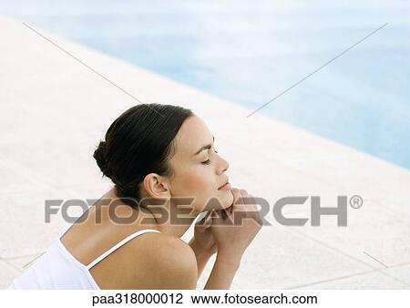 Woman with eyes closed by edge of pool View Large Photo Image Stock Image - Woman with eyes closed by edge of pool. Fotosearch