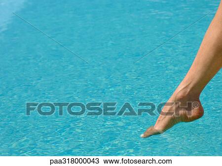 Woman's foot, testing water in pool View Large Photo Image Stock Image - Woman's foot, testing water in pool. Fotosearch