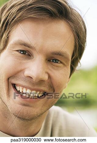 Young man smiling, portrait View Large Photo Image Stock Image - Young man smiling, portrait. Fotosearch