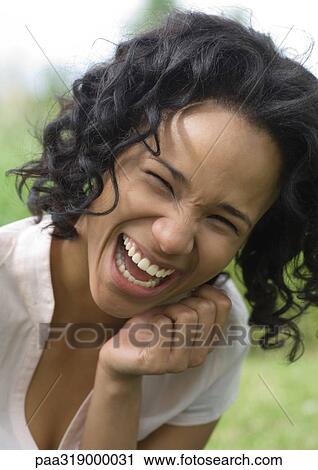 Young woman laughing, portrait View Large Photo Image Stock Image - Young woman laughing, portrait. Fotosearch