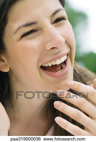 Stock Photograph - Young woman laughing. Fotosearch