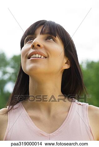 Young woman looking up, portrait View Large Photo Image Picture - Young woman looking up, portrait. Fotosearch