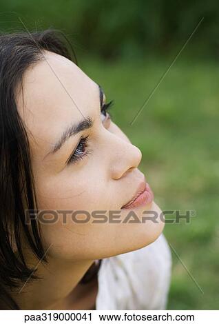 Young woman looking up, portrait View Large Photo Image Stock Image - Young woman looking up, portrait. Fotosearch