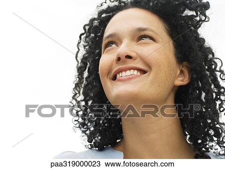 Stock Image - Young woman smiling, portrait. Fotosearch