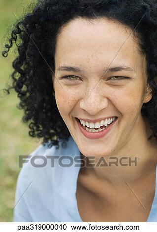 Stock Image - Young woman smiling, portrait. Fotosearch