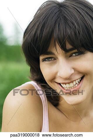 Young woman smiling, portrait View Large Photo Image Stock Photo - Young woman smiling, portrait. Fotosearch